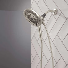 Hand shower with round spray head on wall mount, flexible hose and spray nozzles