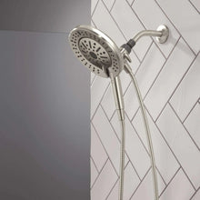 Wall-mounted hand shower with round spray head and flexible hose, chrome finish