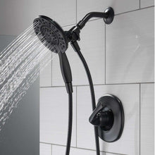 Black overhead rain-style shower head with spray face and flexible hose