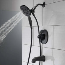 Black shower faucet with overhead shower head, hose, and round wall mount