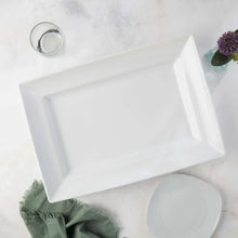 White rectangular stoneware platter with raised rim, empty