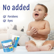 Baby with Desitin Daily Defense diaper rash cream and small container