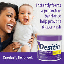 Desitin Maximum Strength diaper rash cream tub beside baby and caregiver