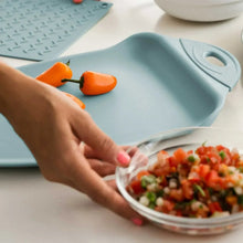 Blue-toned cutting board with built-in scoop area, peppers shown