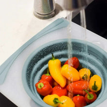 Blue-toned over-sink strainer insert with rinsed peppers
