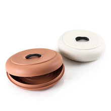 Tortilla warmer set with terra-cotta and white lids, each with a black handle