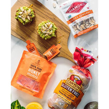 Diamond sliced almonds bag on a table with other snack packages and honey.