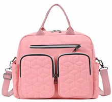 Pink quilted diaper bag tote with front zip pocket and two front compartments