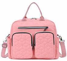 Pink diaper bag tote with two quilted insulated front pockets and zip top