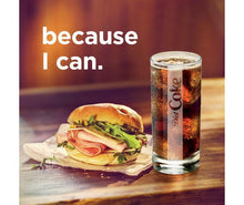 Diet Coke can beside burger on table