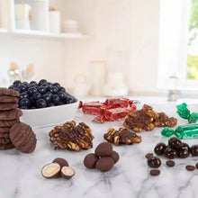 Chocolate assortment in white compartments with mixed candies and wrapped pieces