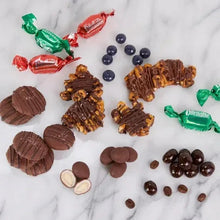 Assorted chocolate candies and truffles with green and red wrapped pieces
