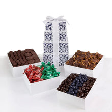 Chocolate gift tower box wrapped in white and navy pattern with a bow ribbon