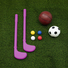 Pink goal posts with basketball, soccer ball, and foam balls on grass