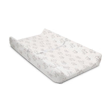 Contoured changing pad with white plush cover and allover bear character line print