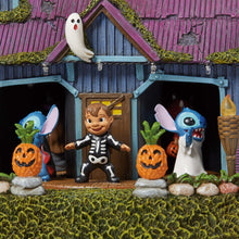 Halloween house doorway with Stitch figure, skeleton elf, and jack-o'-lanterns