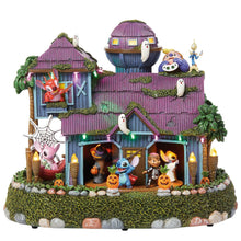 Halloween animated house with open doorway lights and Halloween character figurines.