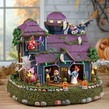 Halloween animated house with purple shingled roof, lit windows, and character figures.