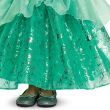 Green tiered tulle skirt with shimmering swirl pattern; glitter flats visible