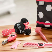 Baby Minnie grooming tools laid out with pink brushes, comb, and zip pouch