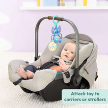 Stitch tummy tumble activity toy hanging from a baby car seat frame