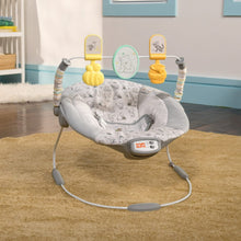 Gray Pooh-print vibrating bouncer with yellow character toy mounts