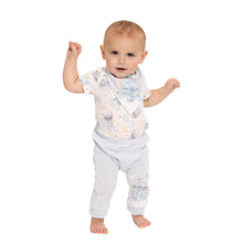 Newborn character-print bodysuit with light fabric and gray pants on model