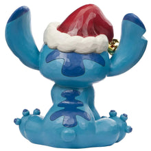 Blue Stitch holiday statue with red Santa hat, gold bell, and raised arms
