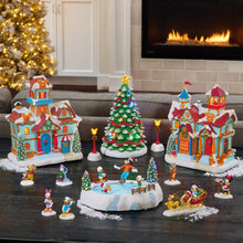 Disney holiday village set with snowy castle buildings, lit tree, and small character figures