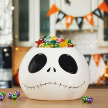 Skellington Halloween treat bowl, white with black eyes and stitched smile, filled with candies