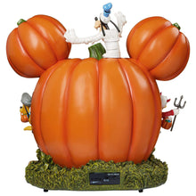 Back view of Halloween pumpkin house display with orange pumpkin shell and figure on top