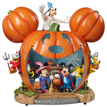 Halloween pumpkin house display with Mickey and friends, orange pumpkin shell and web details