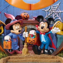 Close-up of Halloween pumpkin house interior with Mickey and Minnie holding candy pails