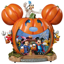 Halloween pumpkin house display with Mickey and friends, orange pumpkin shell and open front