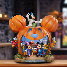Halloween pumpkin house display with Mickey and friends figures inside, orange double-doors