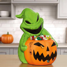 Halloween treat bowl shaped like a green monster with a jack-o'-lantern face