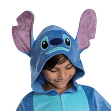 Smiling child in alien hood with big blue face and purple ears