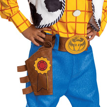 Woody-style children’s costume detail: blue pants, gold emblem belt, brown pouch accessories
