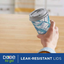 Paper to-go cup with gray leak-resistant lid, blue printed design, held in hand