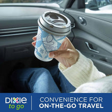 Paper to-go cup with gray leak-resistant lid, blue geometric print, held in hand