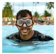 Swimmer wearing adult swim mask with black frame, clear lenses and yellow accents