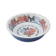 Blue ceramic pie dish with floral rim and scalloped edge, round serving bowl