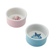 Round ceramic ramekins, pink and blue, each with butterfly floral interior art.