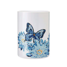 White stoneware crock with blue butterfly and floral mosaic print, cylindrical shape