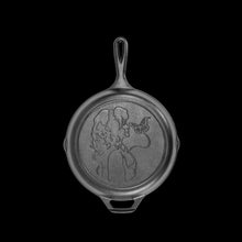 Seasoned cast iron skillet with handle, round base and etched Dolly portrait design