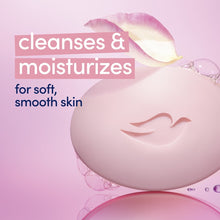 Pink soap bar with Dove emblem, close-up over bubbles with “cleanses & moisturizes” text