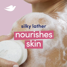 Creamy soap lather swirling over a pale soap bar