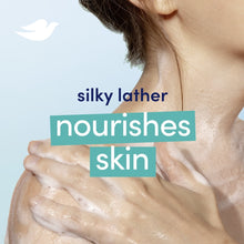 White beauty bar soap with dove emblem held over silky lather on skin