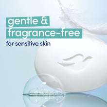 White beauty bar soap with dove emblem over bubbles and smooth lather on skin