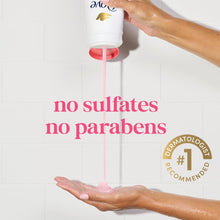Dove body wash bottle dispensing pink gel onto hands